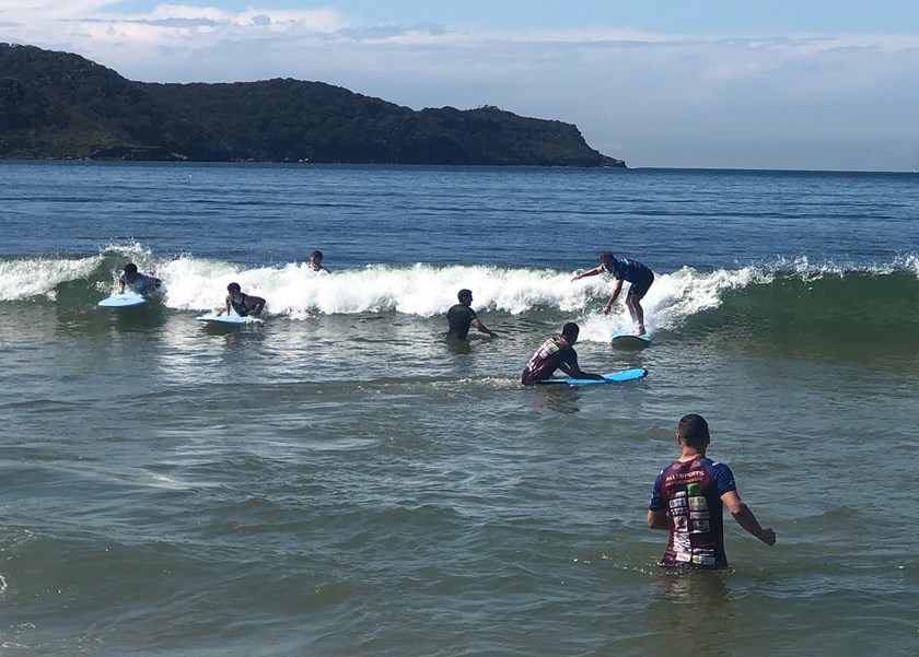 The Dolphins Academy learn to surf together.